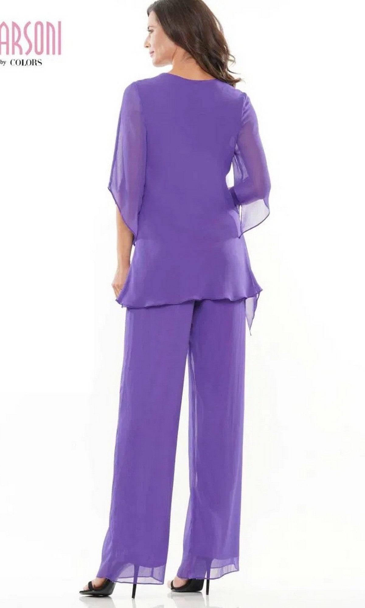 A woman faces away, wearing the Marsoni M308 long formal pantsuit—loose-fitting, sheer purple chiffon with matching wide-leg pants and black heels—against a plain white background.